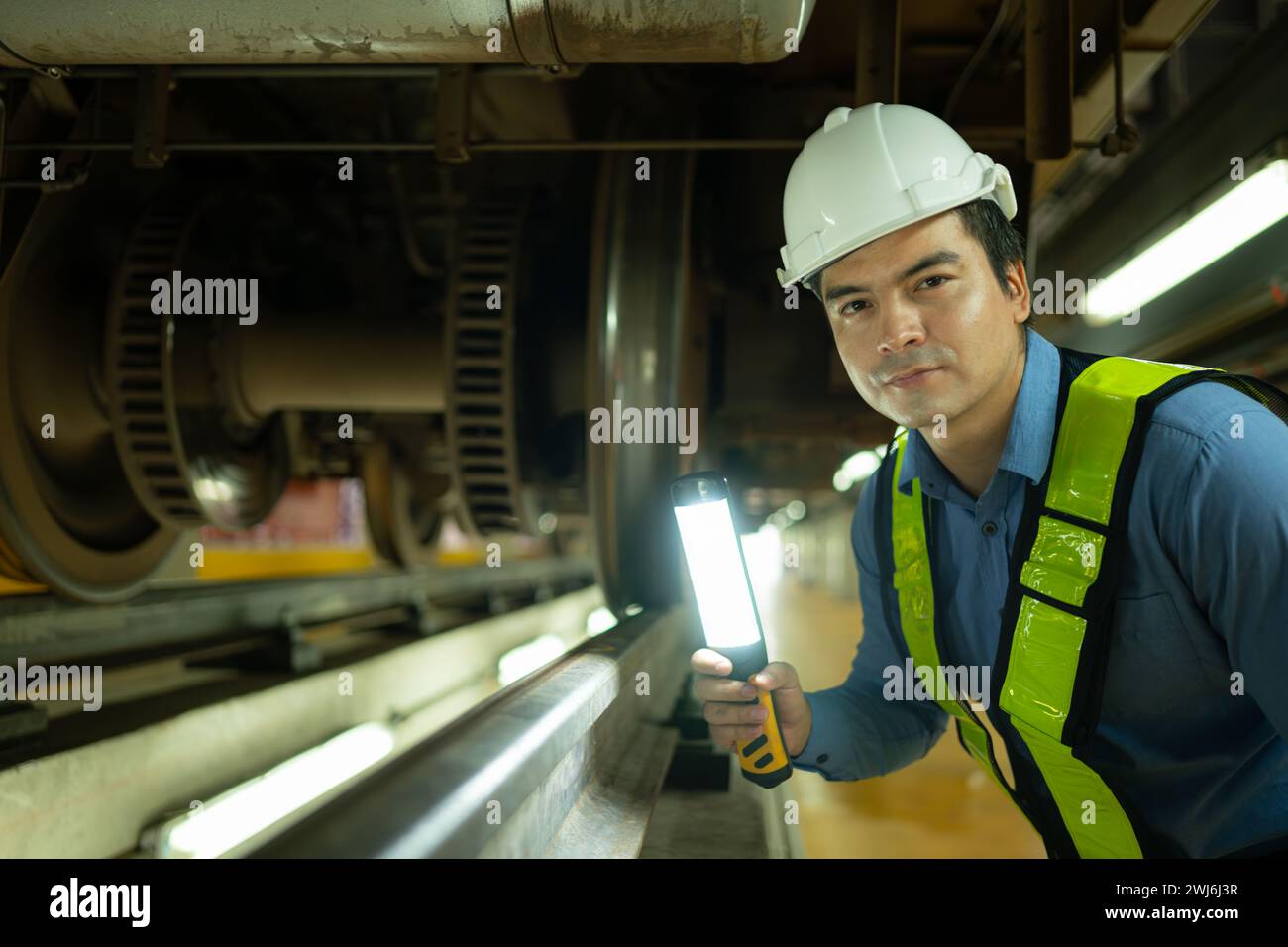 Engineers for electric trains After detecting difficulties with the electric train's machinery use searchlights to locate and ch Stock Photo