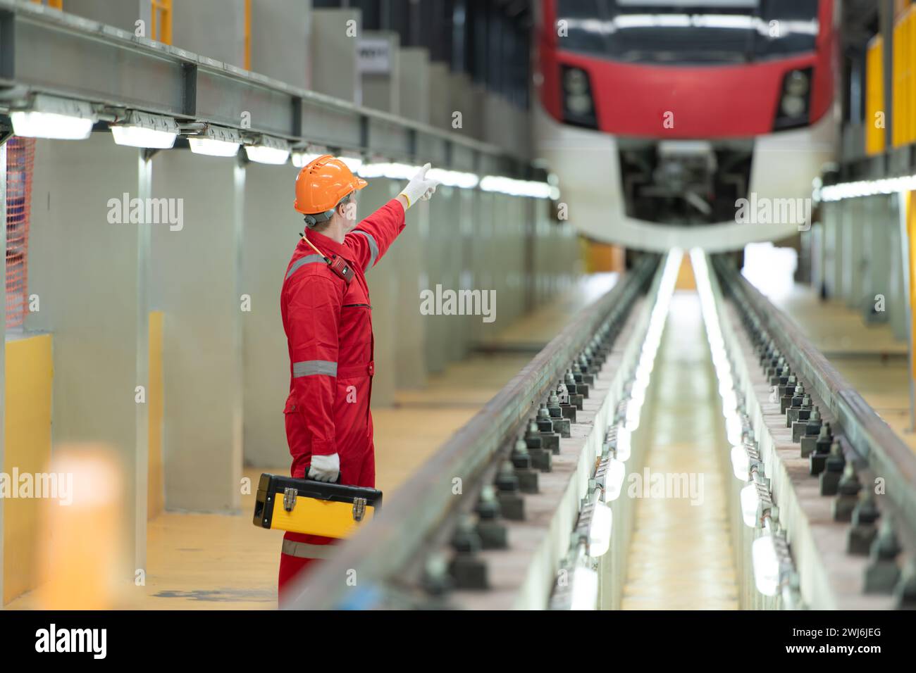 Train Inspection Building Electric vehicle engineer with toolbox inspect the machinery of the ...