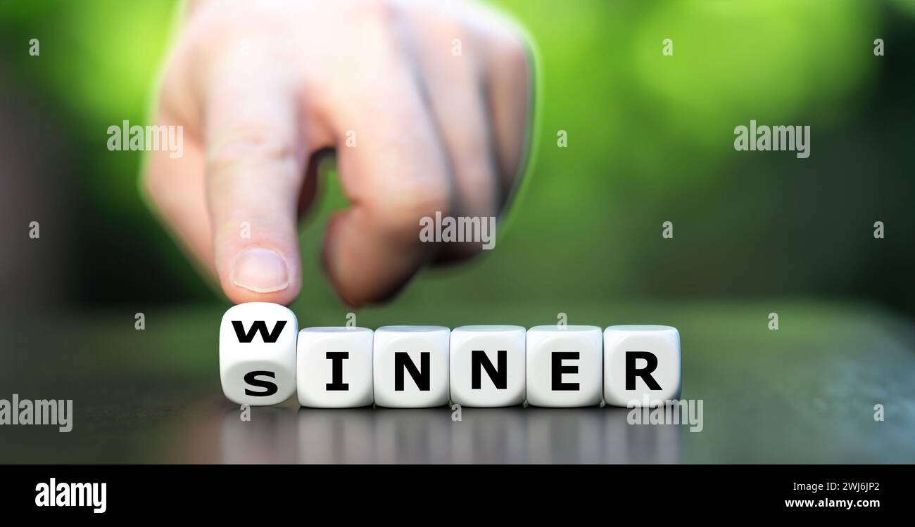 Hand turns dice and changes the word sinner to winner. Symbol for stop