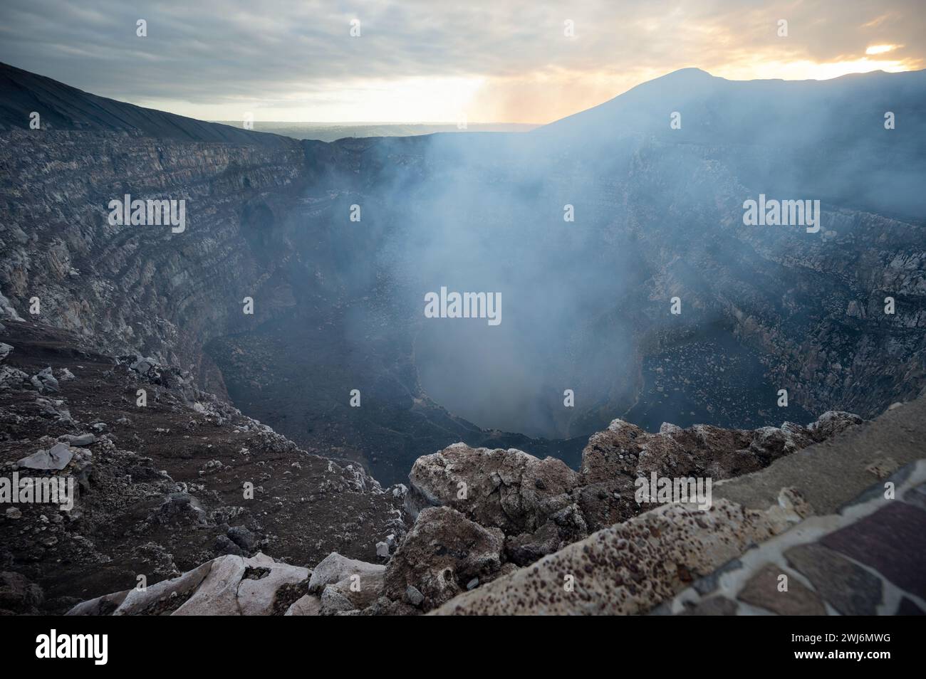 Masaya volcano crater rocky hole with smoke emission gas going up Stock Photo