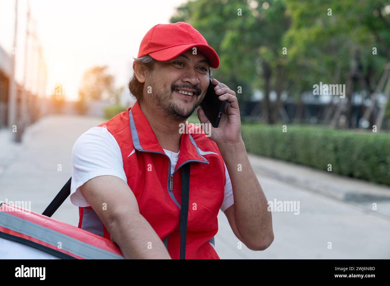 Delivery person riding a bicycle for food delivery Stock Photo