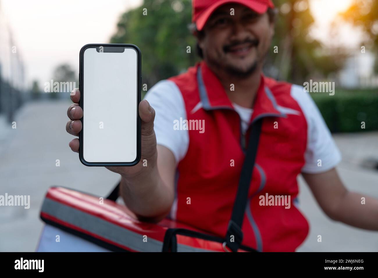 Delivery person riding a bicycle for food delivery Stock Photo