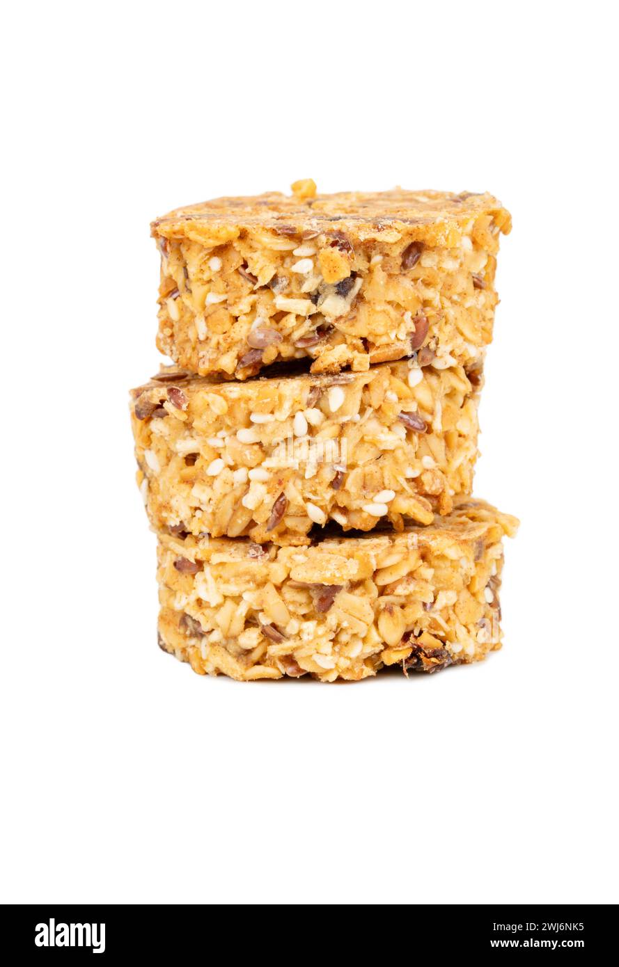 Three granola cookies stacked with healthy cereals and grains in honey isolated on white background Stock Photo