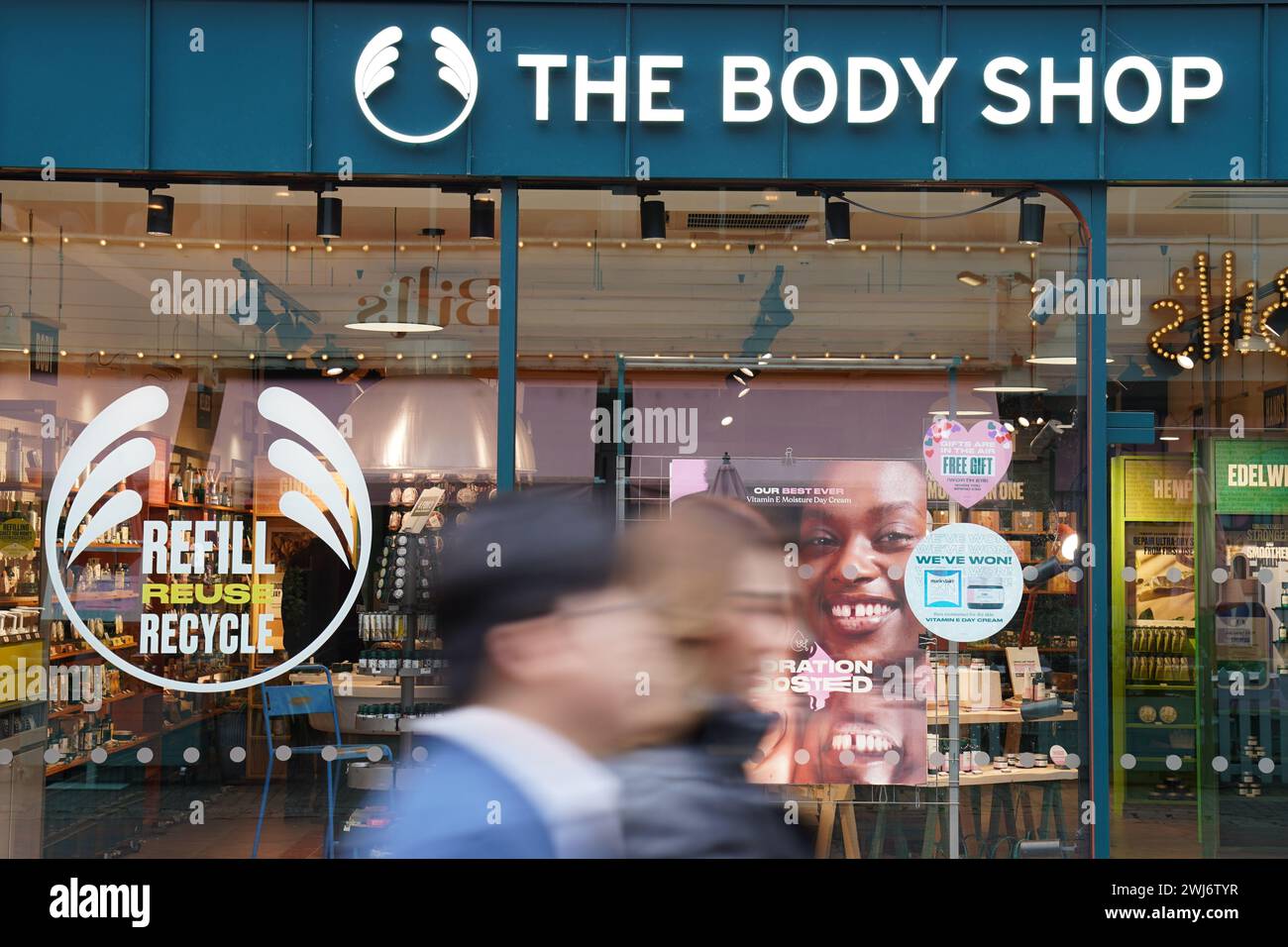 People walk past a Body Shop store in Canterbury. The Body Shop has hired administrators, putting thousands of jobs at the cosmetics chain at risk. The retailer, which runs more than 200 shops across the UK, has appointed insolvency experts from FRP Advisory to oversee the process. Picture date: Tuesday February 13, 2024. Stock Photo