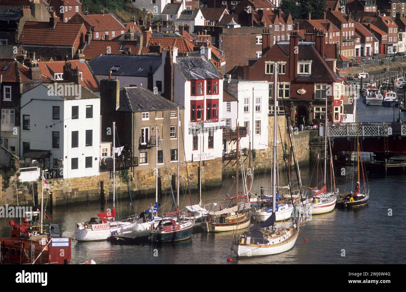 Uk, Yorkshire, Whitby, Waterfront With Red Brick Houses And Boats 