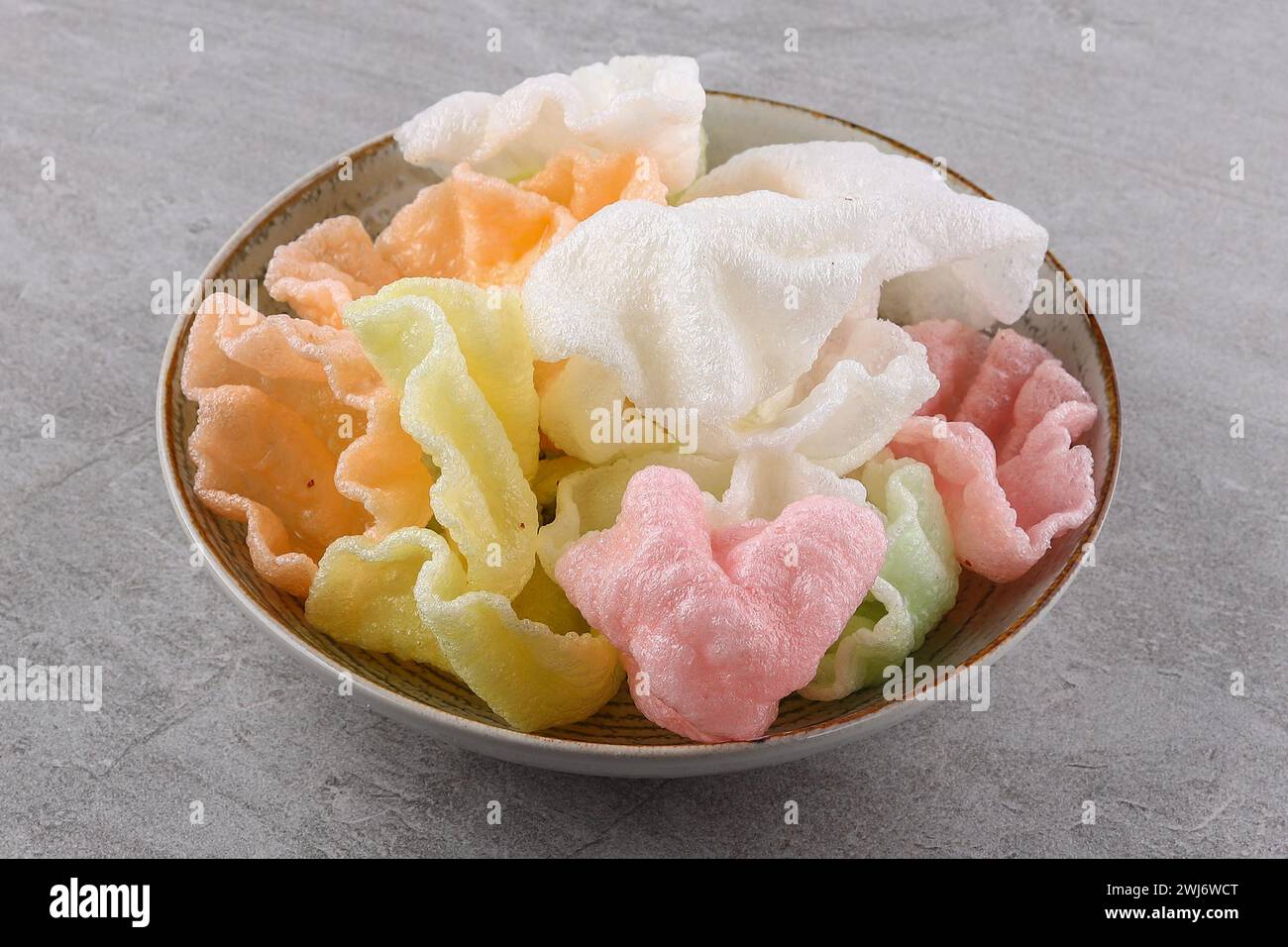 multi-colored rice chips on a stone background, studio food photography ...