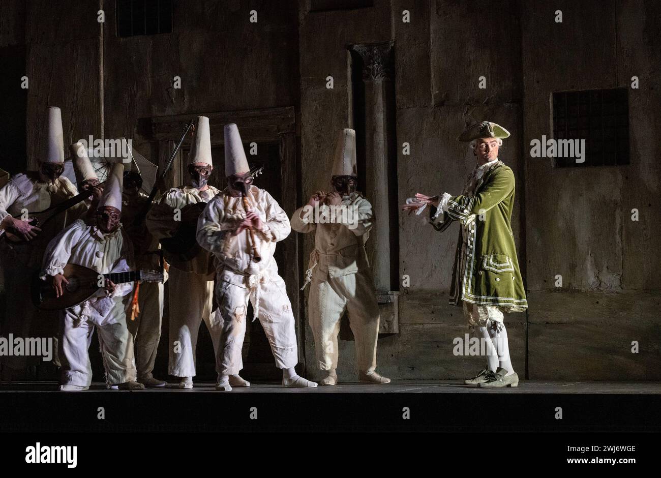 Patrick Alexander Keefe (Fiorello) with strolling street musicians in THE BARBER OF SEVILLE at English National Opera (ENO), London Coliseum, London WC2  12/02/2024  music: Gioachino Rossini  libretto: Cesare Sterbini  conductor: Roderick Cox  design: Tanya McCallin  original lighting: Tom Mannings  original director: Jonathan Miller Stock Photo