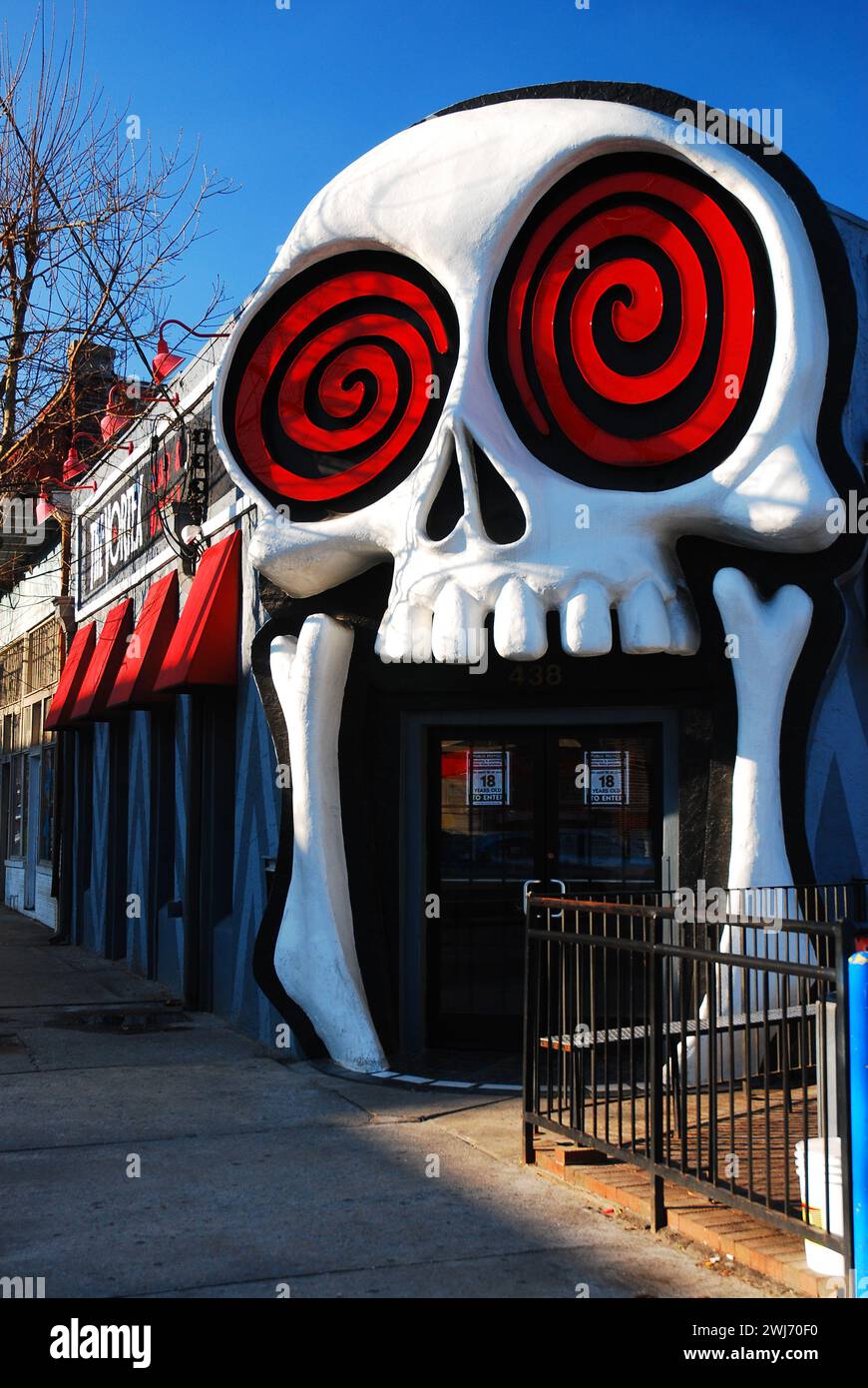 A skull face with crazy eyes marks the entrance to the Vortex, an eclectic nightclub in the Little Five Points neighborhood in Atlanta Stock Photo