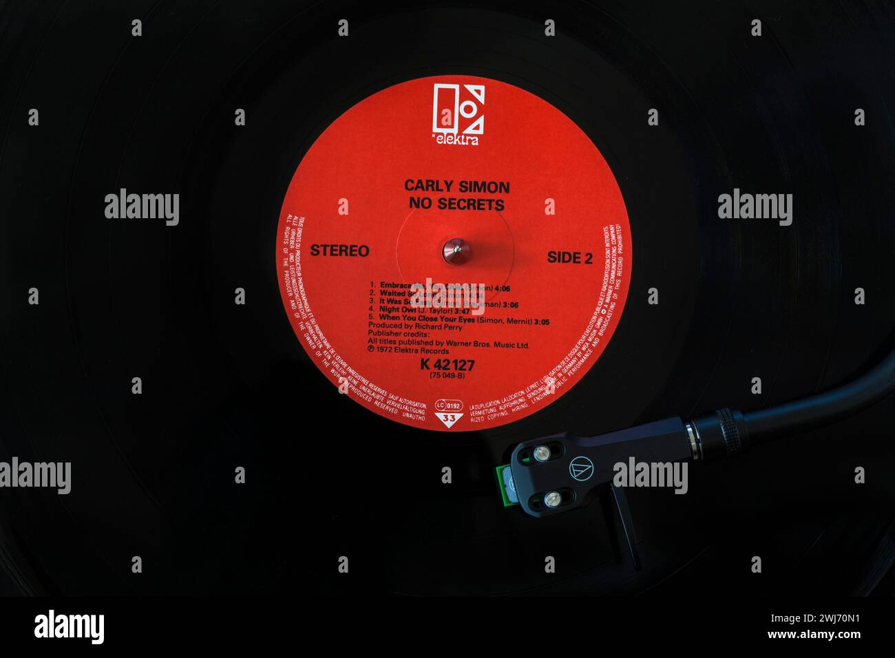 Carly Simon No Secrets vinyl record album LP with tonearm, cartridge, headshell and stylus on turntable record player - 1972 Stock Photo
