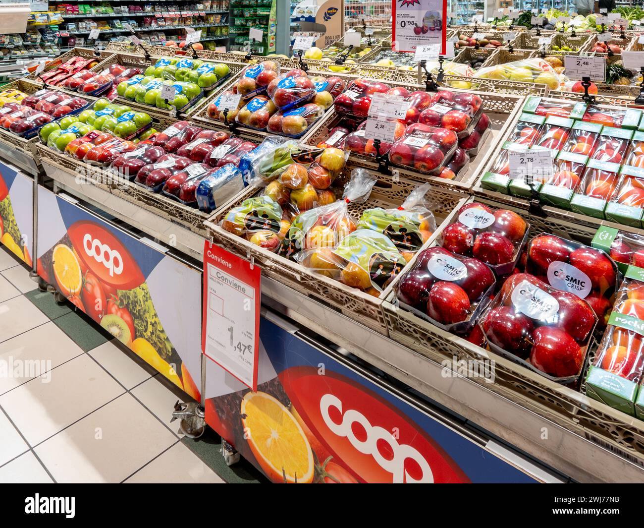 Bra, Italy - February 13, 2024: Apples of various types in plastic packaging displayed on stall for sale in Italian COOP supermarket Stock Photo