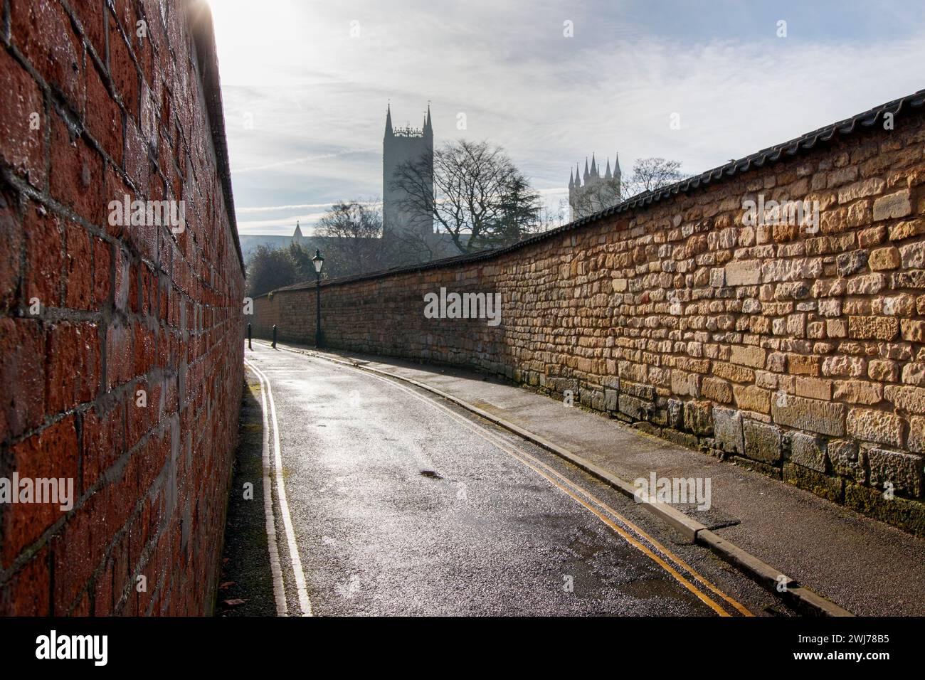 East Bight, a back street dating from 1150 that skirts the former defences to the East and North of Roman Lincoln. The street starts at Newport Arch, Bailgate and finishes at Lincoln Cathedral. It also formed the boundary of the parishes of St Margaret on the north and east, and St Paul and St Mary Magdalene on the south. In Lincoln Lincolnshire.     East Bight has held many names over the years including Bight Lane, Beight End, Thomas a Becketts Lane, Tom a Beight Lane, Bit Lane, Turn-a-Back Lane, Tomabeck Lane. 'Bight' means 'bend' or land in the bend'. Stock Photo