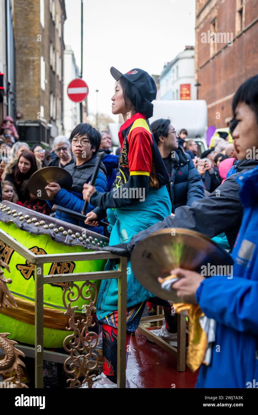 London. UK- 02.11.2024. A female drummer performing in the Chinese New Year celebration parade in China Town. Stock Photo