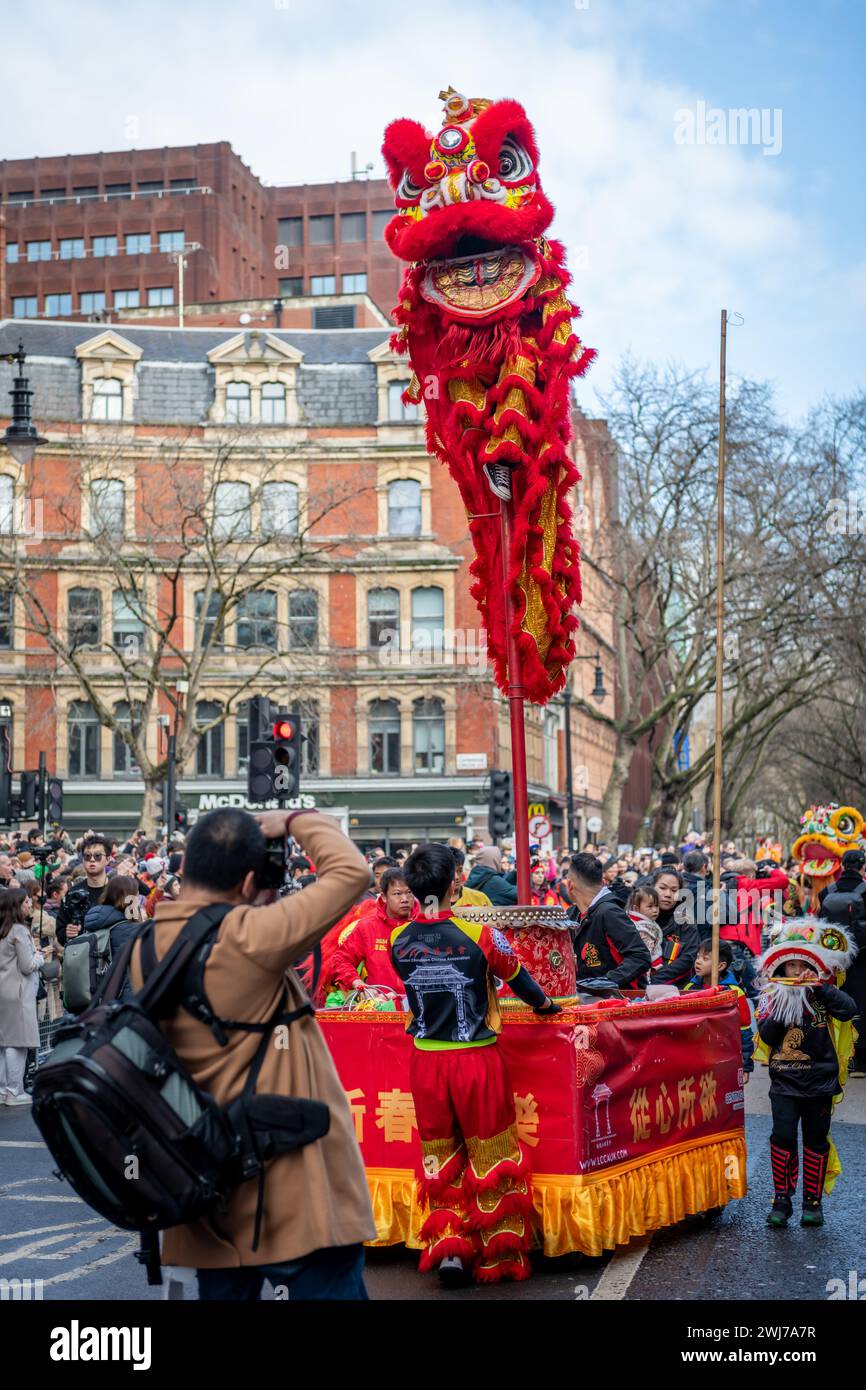 London. UK- 02.11.2024. A child performing a Lion Dance of a special pole in the Chinese New Year celebration parade in China Town. Stock Photo