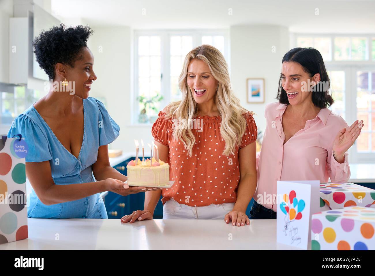 three-mature-women-meeting-at-home-to-celebrate-friend-s-birthday-with