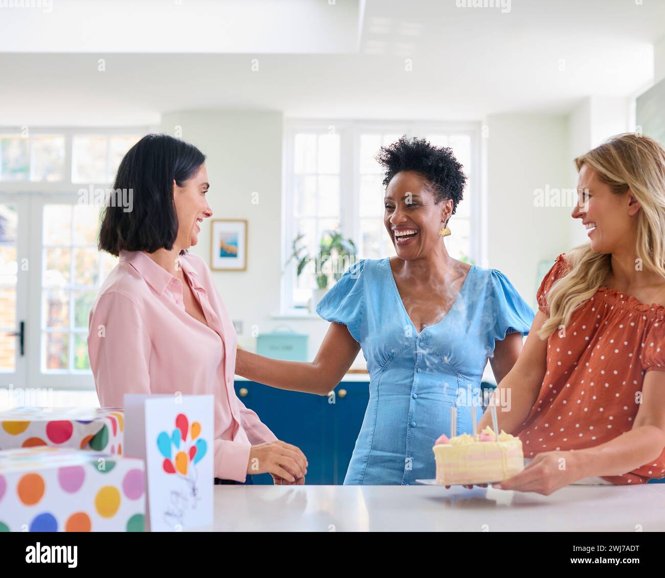 three-mature-women-meeting-at-home-to-celebrate-friend-s-birthday-with
