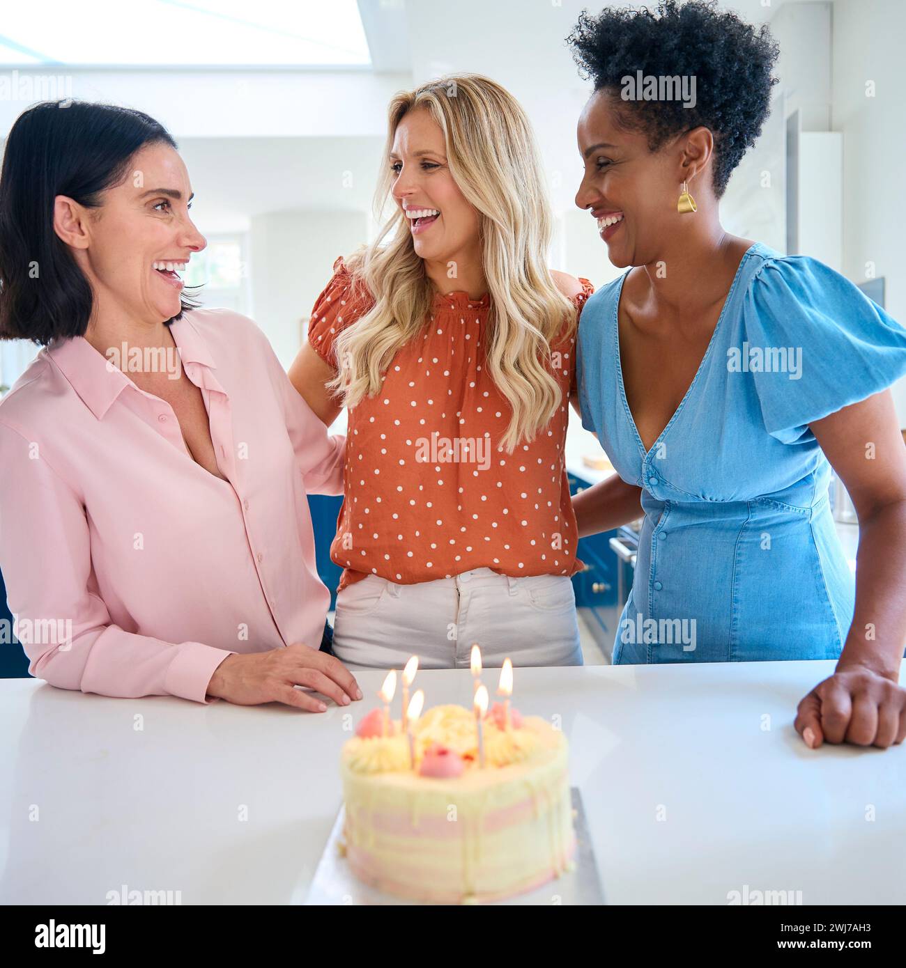three-mature-women-meeting-at-home-to-celebrate-friend-s-birthday-with