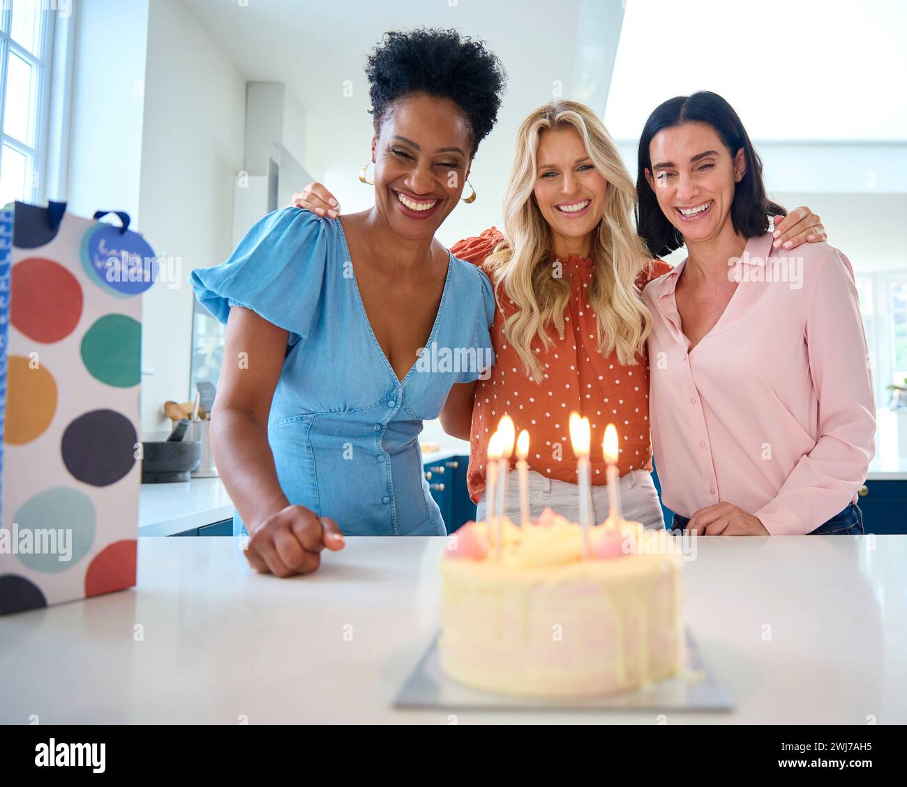 three-mature-women-meeting-at-home-to-celebrate-friend-s-birthday-with