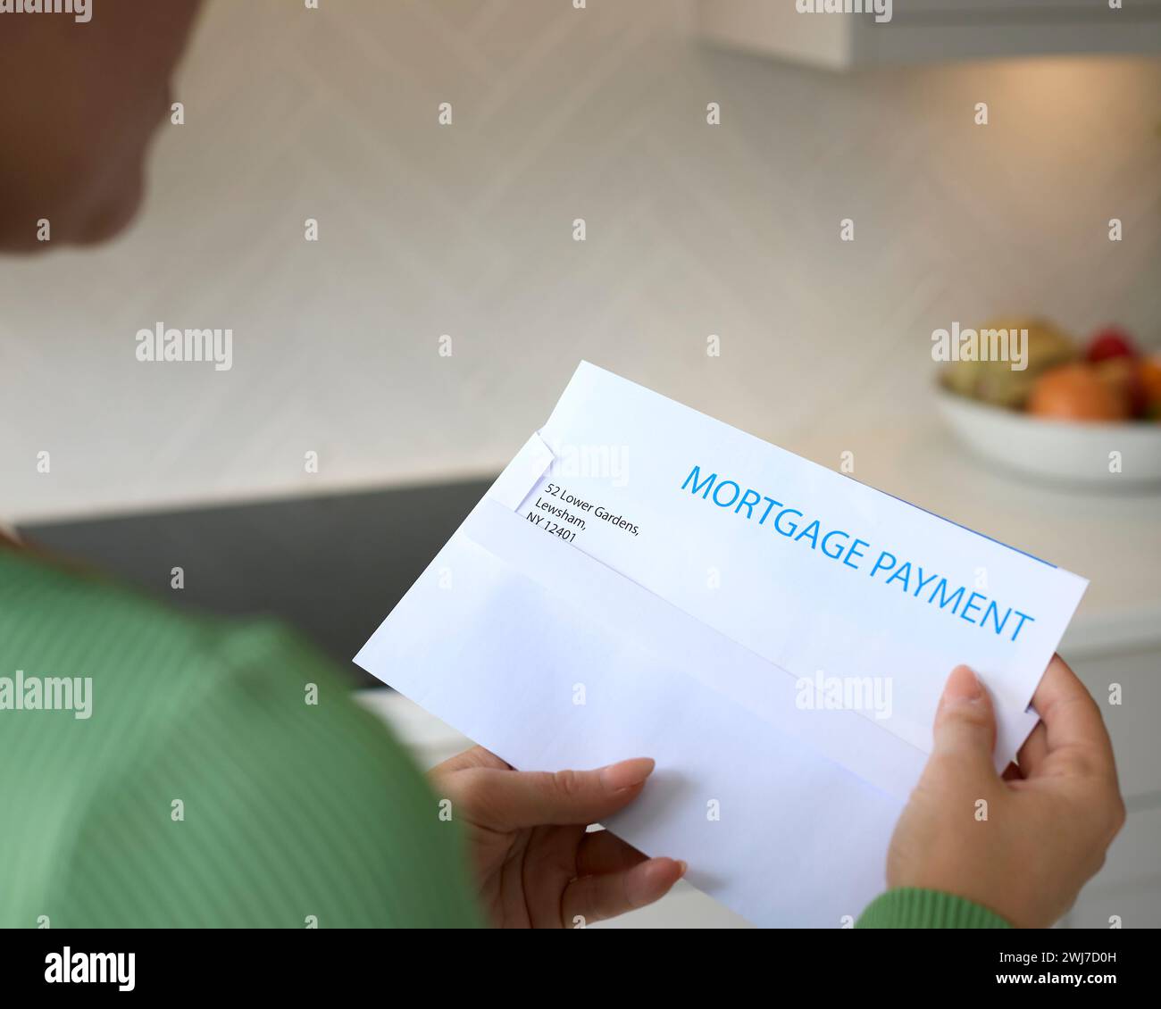 Close Up Of Woman Opening Letter About Increase Repayment On Mortgage During Cost Of Living Crisis Stock Photo