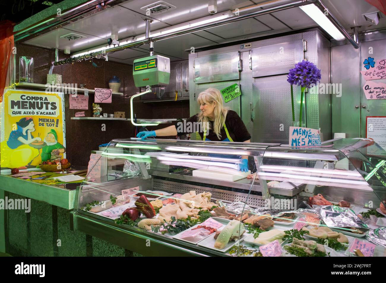 Spotless offal stall with its owner in the old Abaceria Central Market of Barcelona Stock Photo