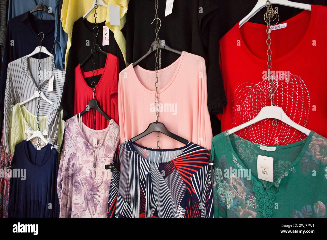 Women clothes hanging on an exterior stall of the Abaceria Central Market in Barcelona Stock Photo