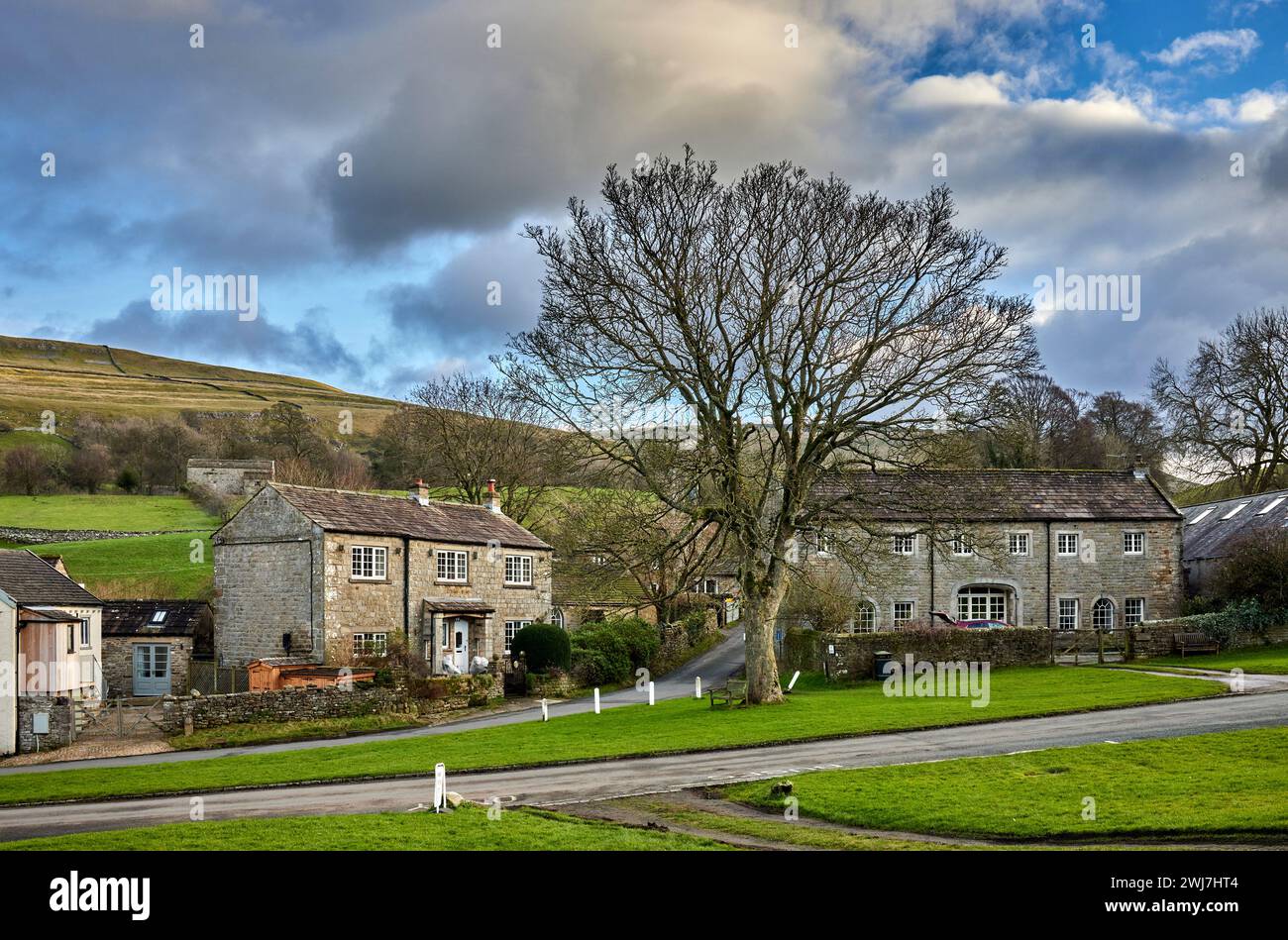 Lit by the late afternoon sun, traditional dales houses present a solid