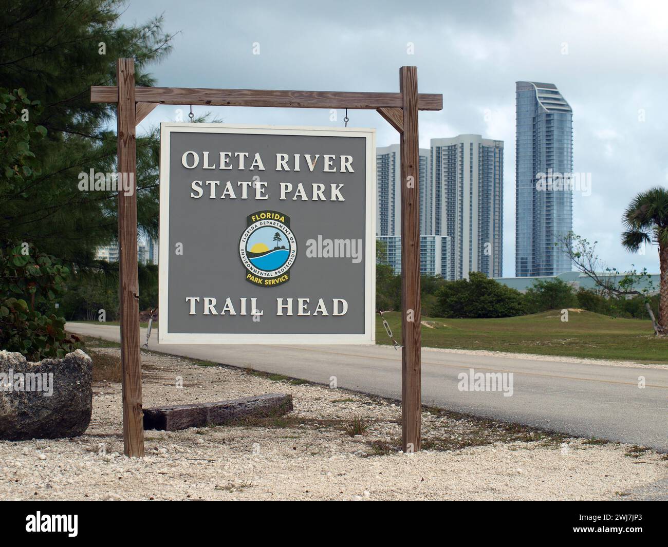 Miami, Florida, United States - January 27, 2024: Trailhead sign in Oleta River State Park. Sunny Isles Beach buildings in the background. Stock Photo