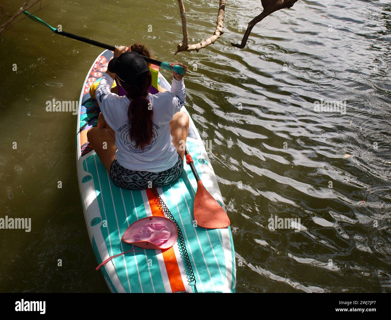 Miami, Florida, United States - January 27, 2024: Lady with a little girl rowing on a paddle board (Location: Oleta River State Park). Stock Photo