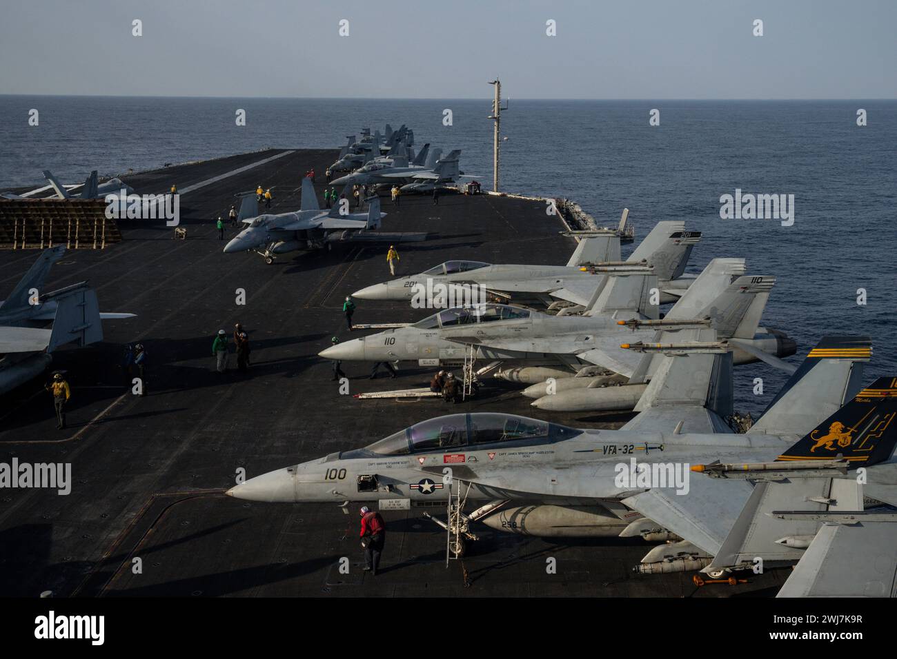 Fighter jets are parked on the deck of the U.S.S. aircraft carrier ...