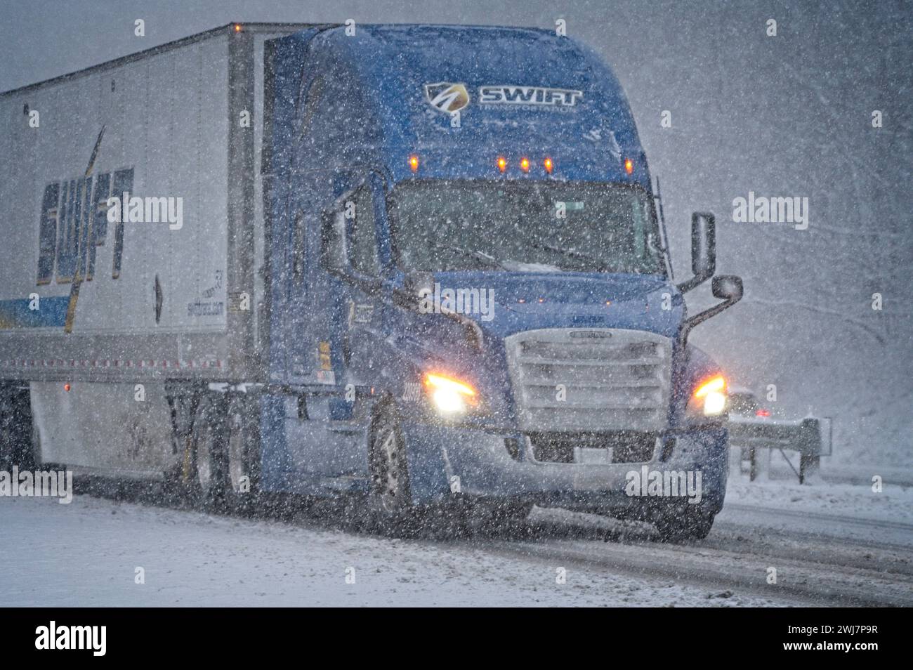 United States: 02-13-2024; A fast moving snow storm closed schools and route 7 at the top of the mountain at Bluemont. Here a tractor trailer makes hi Stock Photo