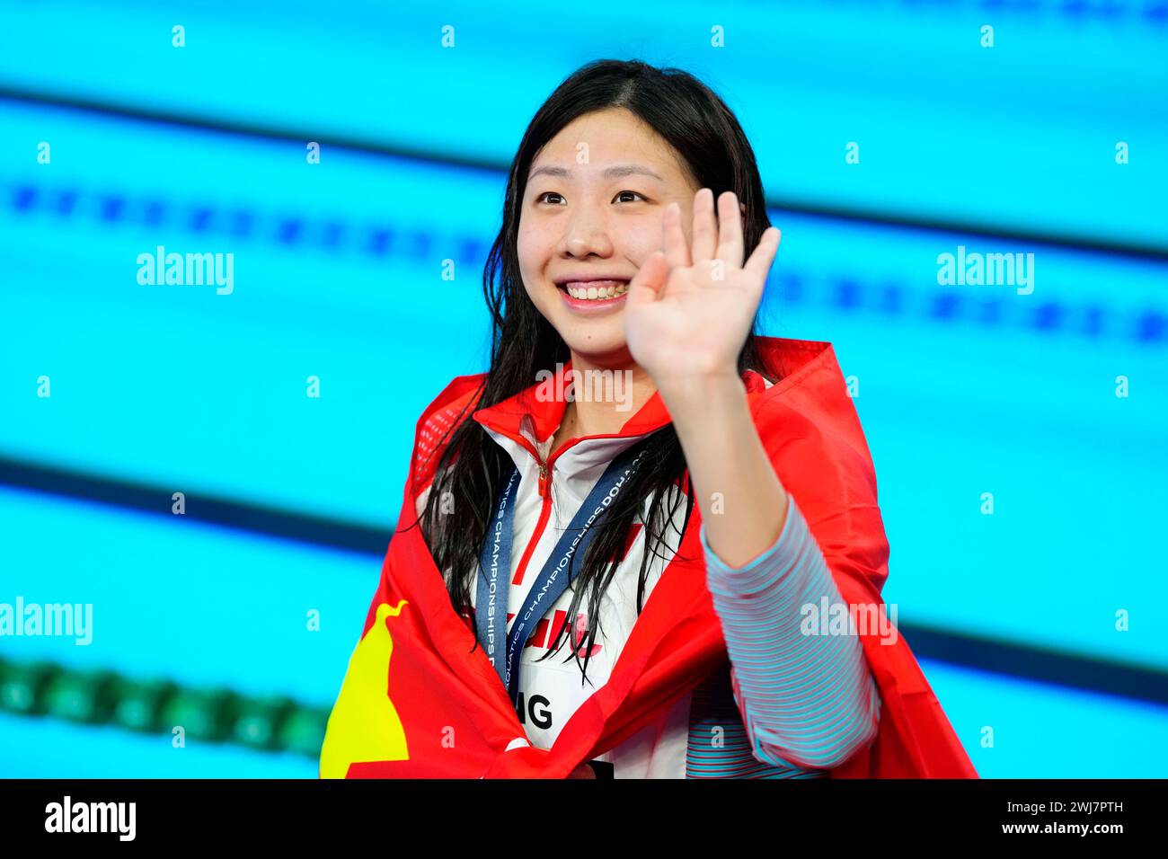 Tang Qianting of China celebrates her gold medal on the podium after