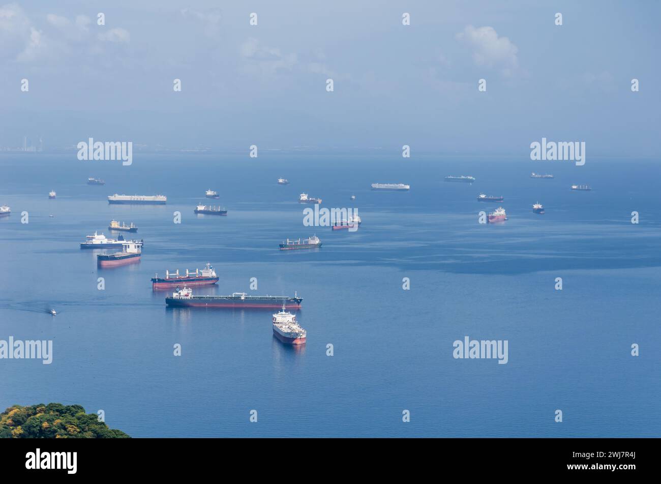 Ships waiting for entrance to the Panama Canal on the Pacific side anchor in designated waiting area offshore from Balboa and the Amador Causeway. Stock Photo