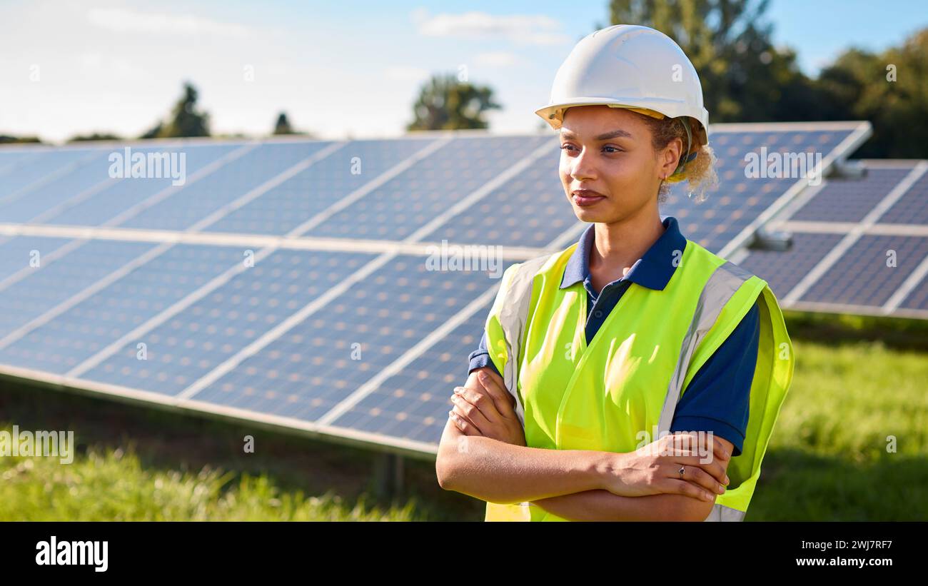 Portrait Of Female Engineer Inspecting Solar Panels In Field Generating ...
