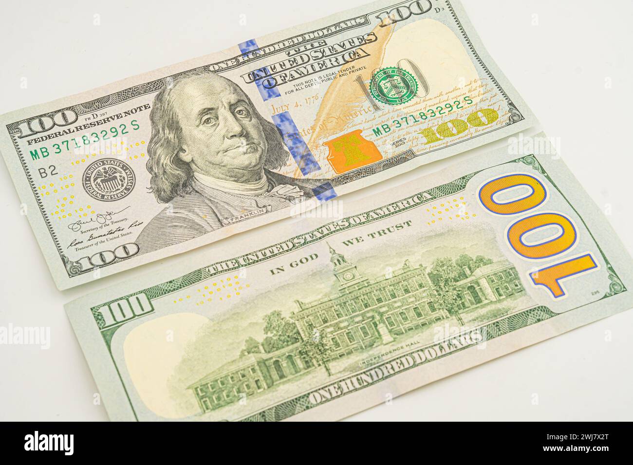 The back of a One hundred dollar bill. A few 100 dollar bills with the back side lying around Stock Photo