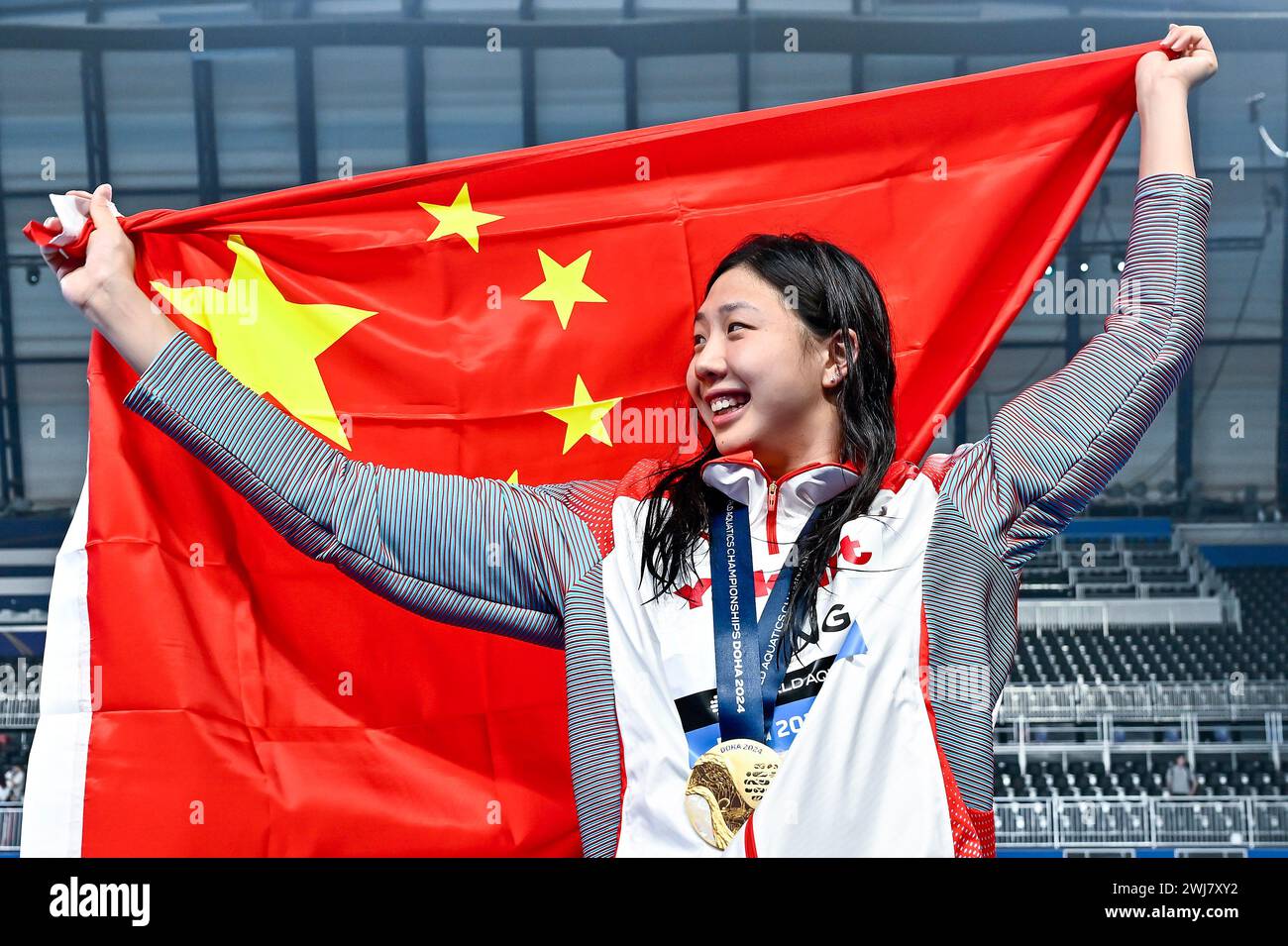 Qianting Tang of China shows the gold medal after competing in the