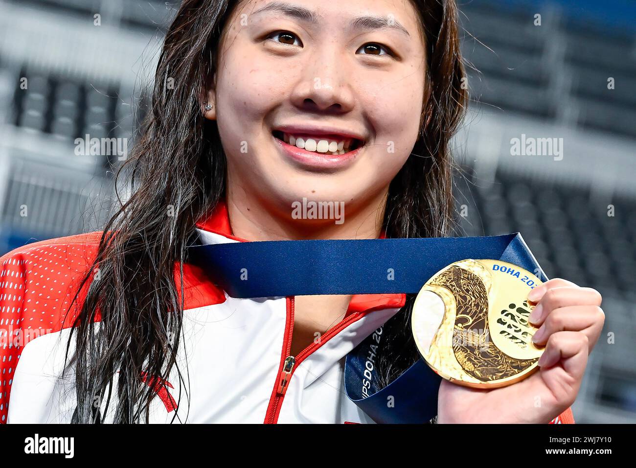 Qianting Tang of China shows the gold medal after competing in the