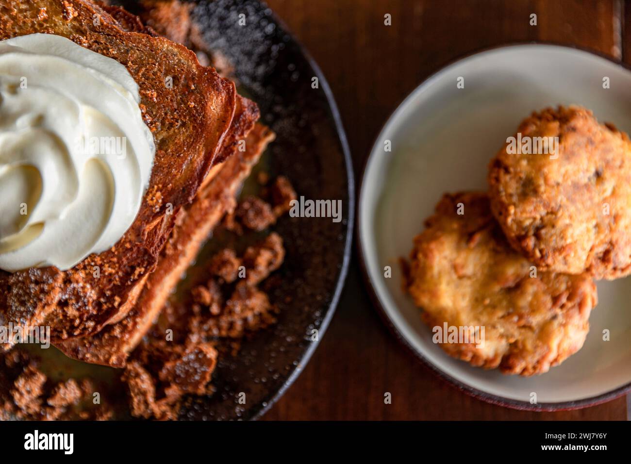 Delicious assortment of dishes, featuring French toast, a mouthwatering cheeseburger, and luscious cream frosting Stock Photo