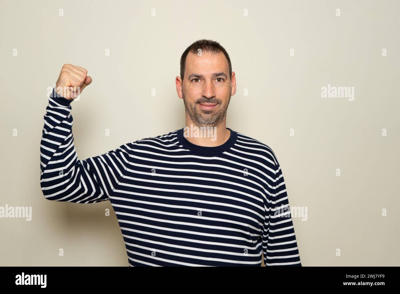 Hispanic man with a beard of 40 years old showing biceps believing that ...