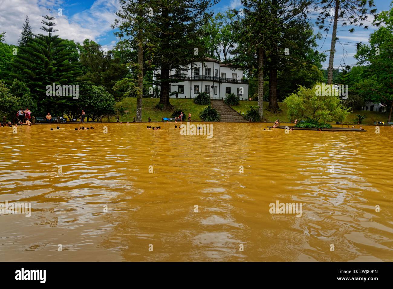 Bathers in the large yellow thermal lake and white spa centre, thermal baths, Furnas, Sao Miguel, Azores, Portugal Stock Photo