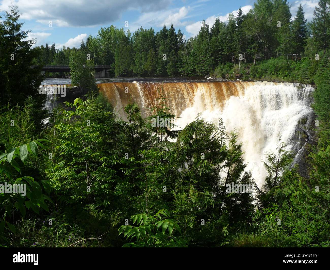 Waterfall with abundant water cascading down Stock Photo