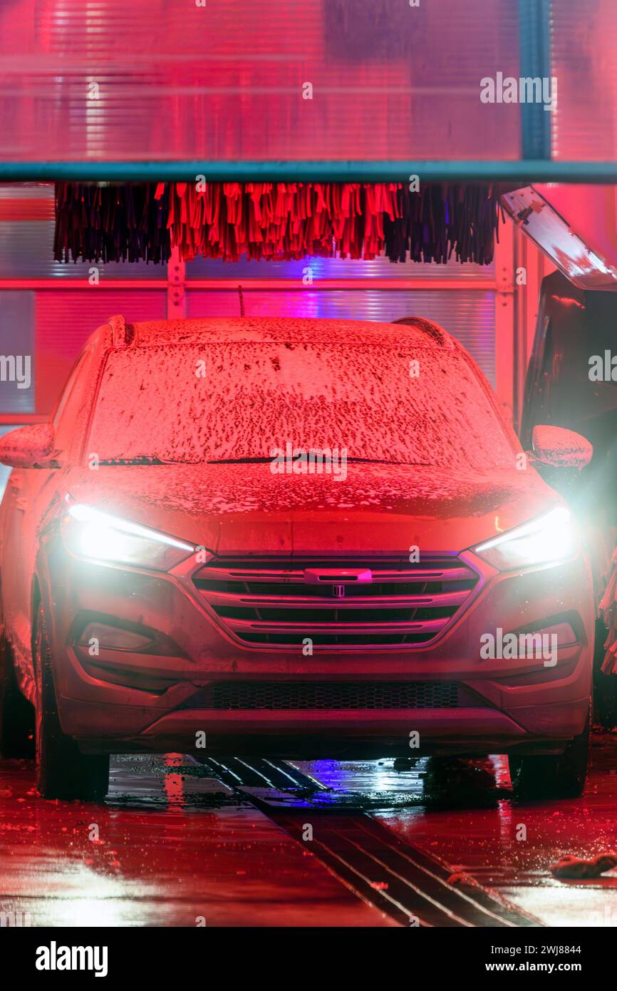 Automatic car wash exit overhead door at night Stock Photo