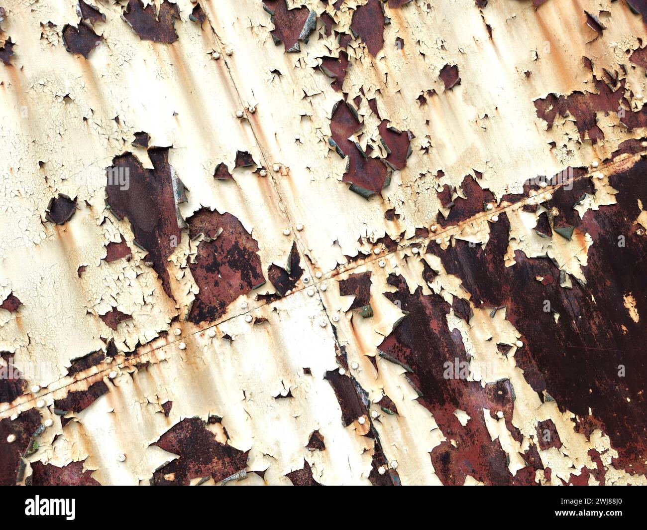 Peeling paint and rust on hangar doors Stock Photo
