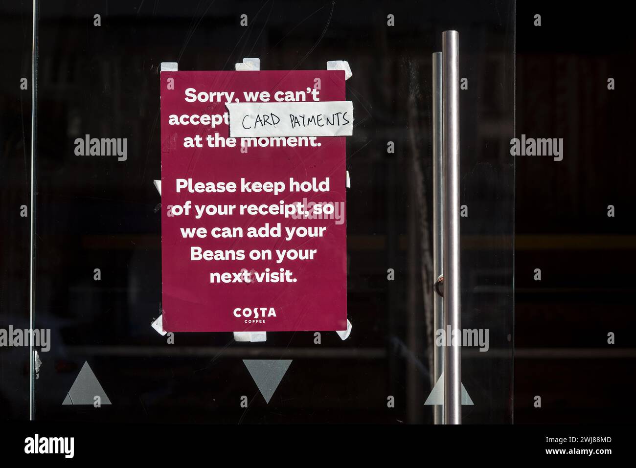 Notice on the door of a Costa Coffee shop inform customers that they can't accept card payments at the moment. Stock Photo