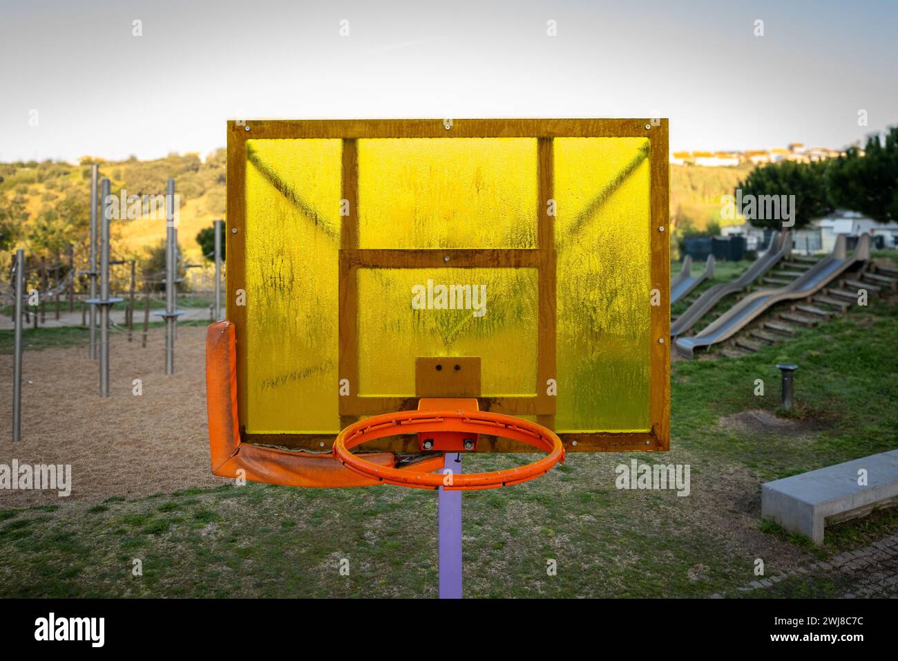 Half basketball courts with view of majestic mountain and overcast gray sky  Stock Photo