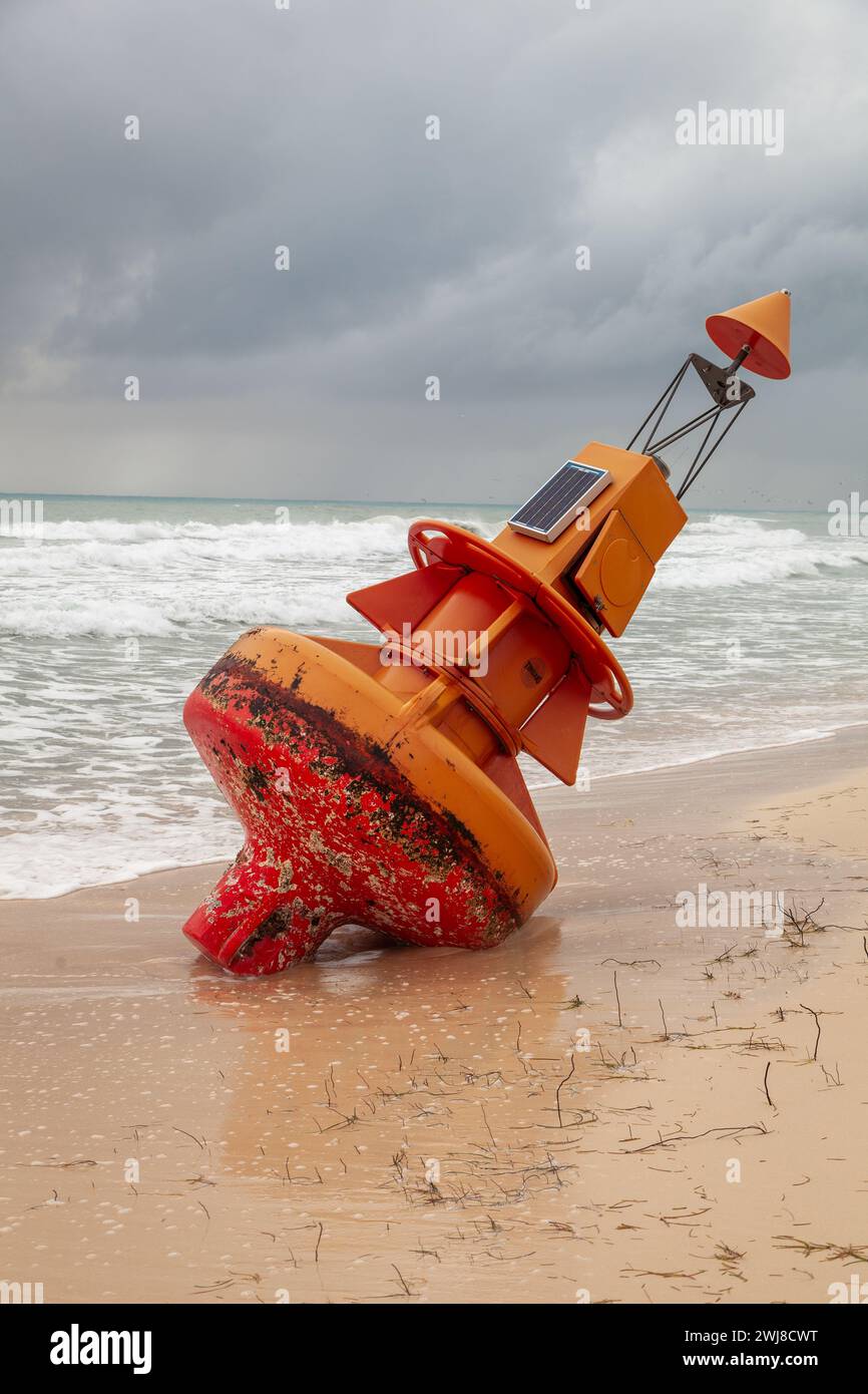 A marine buoy torn from it's mooring beached after a hurricane. Stock Photo