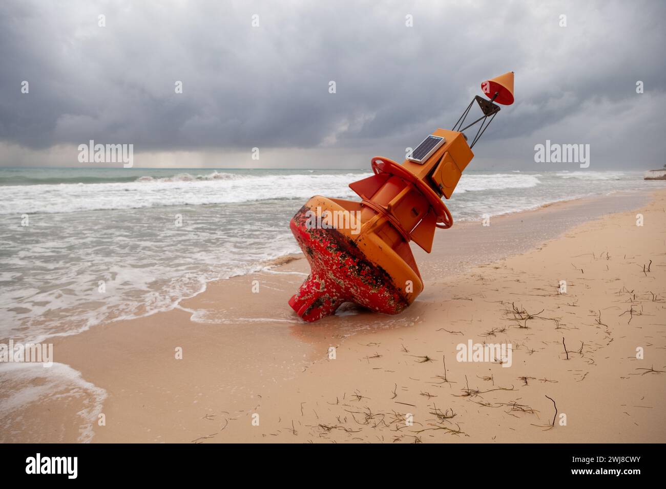 A marine buoy torn from it's mooring beached after a hurricane. Stock Photo