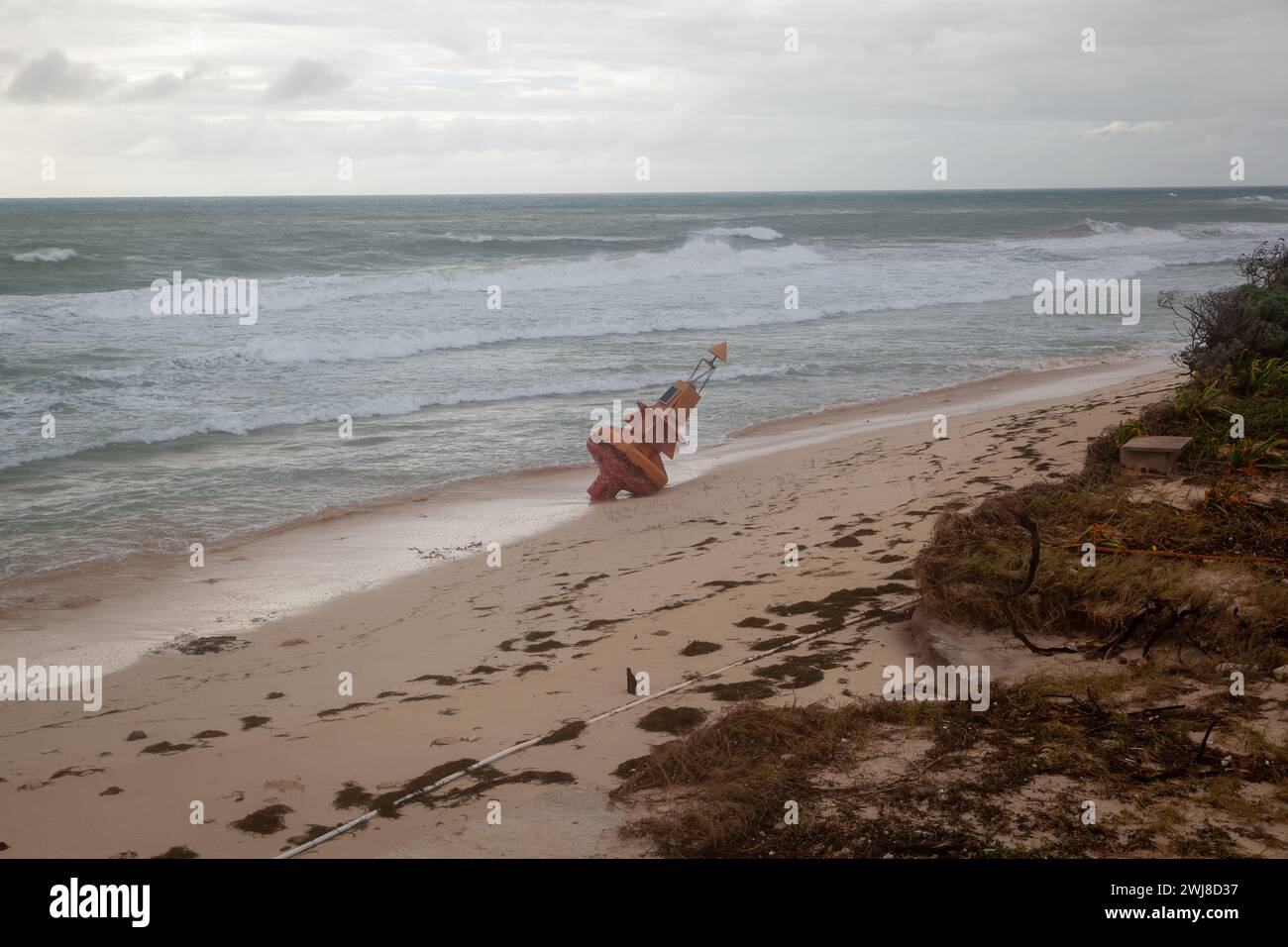 A marine buoy torn from it's mooring beached after a hurricane. Stock Photo