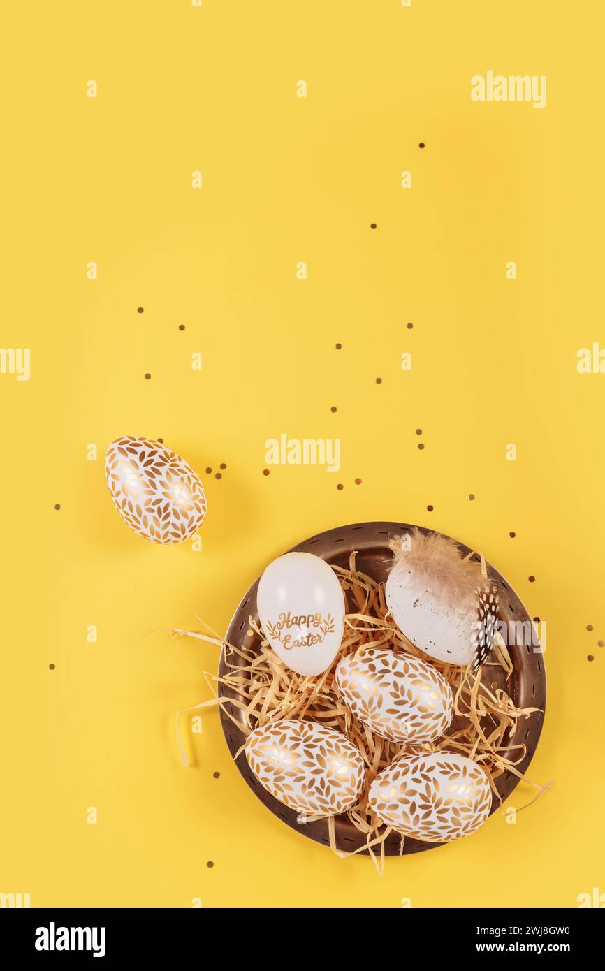 Table place setting and festive easter decor on yellow background Stock Photo