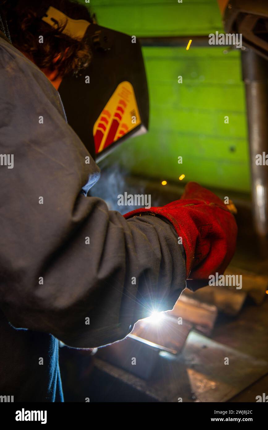 young man welding metal parts Stock Photo