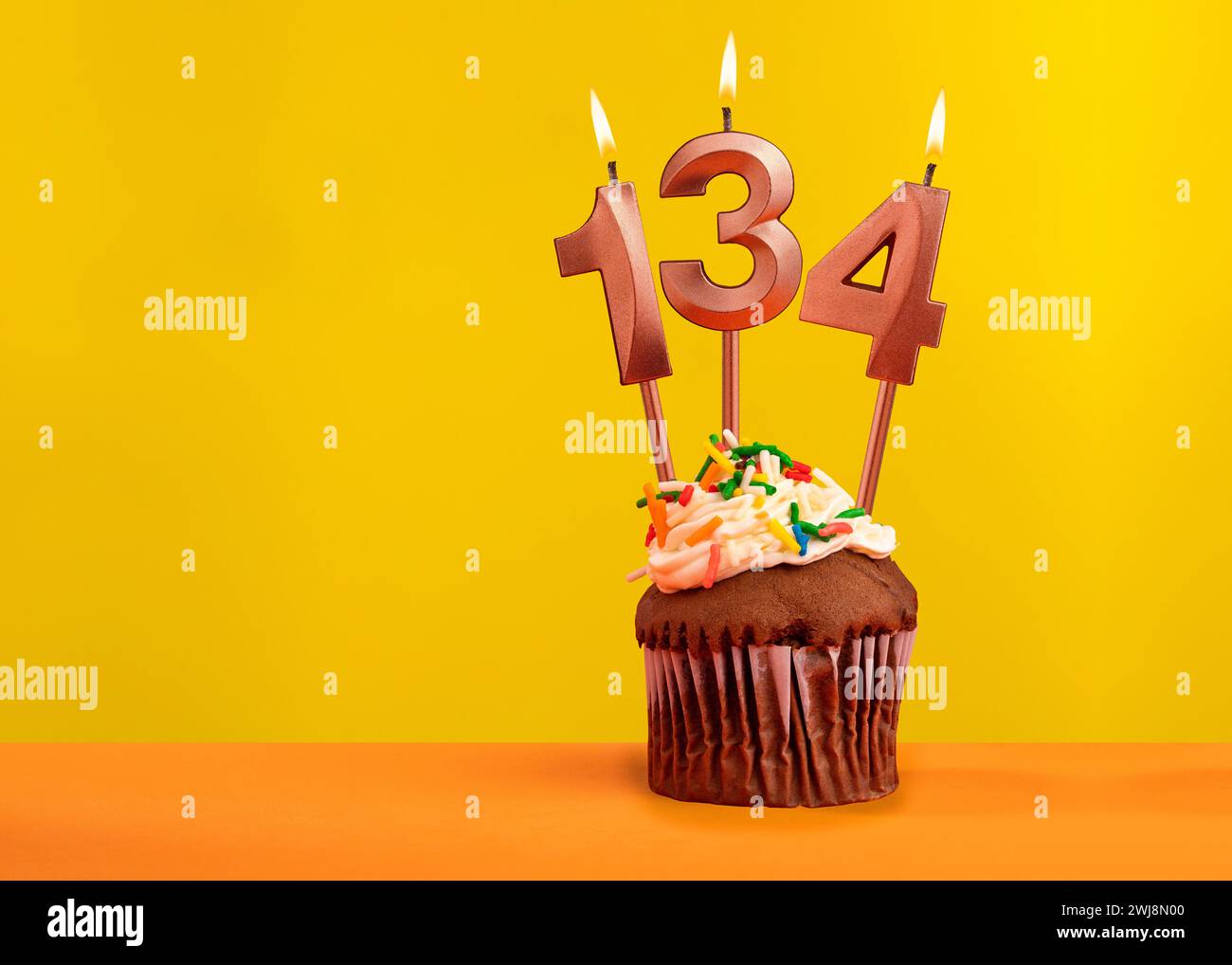Number 134 birthday candle - Celebration on yellow background Stock ...