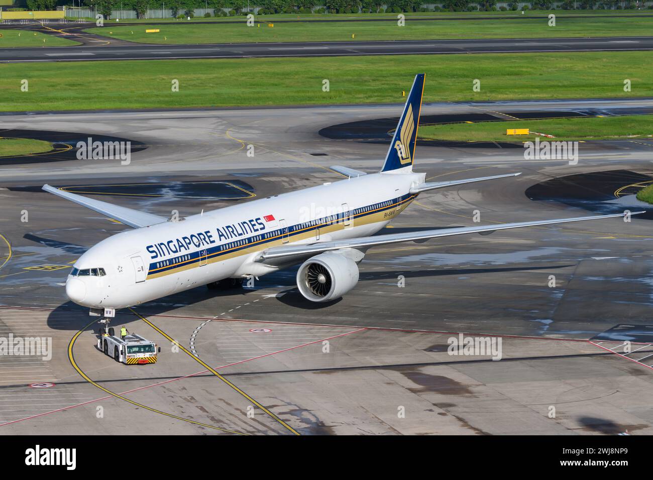 Singapore Airlines Boeing 777 at Changi Airport. Plane B777 during push back. Airplane 777-300ER of Singapore Airlines registered as 9V-SWW. Stock Photo